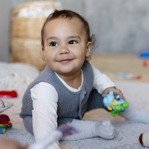 adorable-baby-playing-floor-with-toy